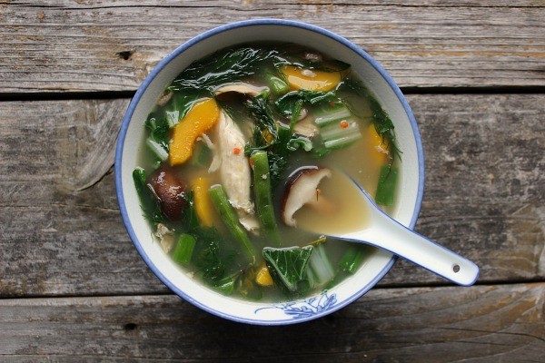Thai herbal soup on wooden table